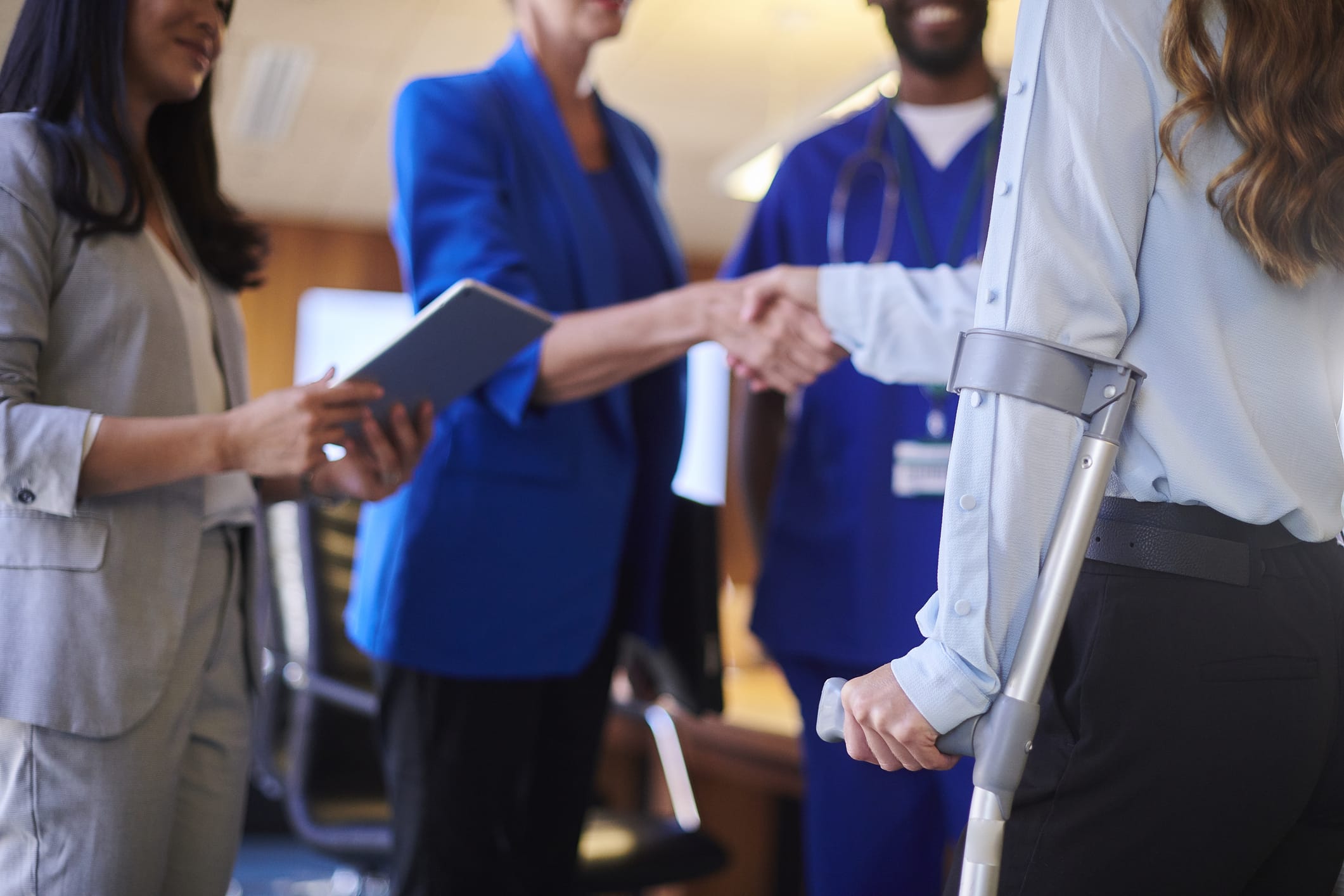 An injured person shaking hands with an advocate